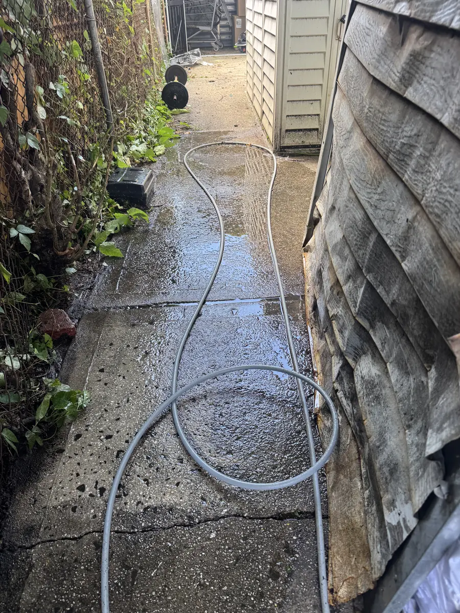 Rear commercial service area during power washing
